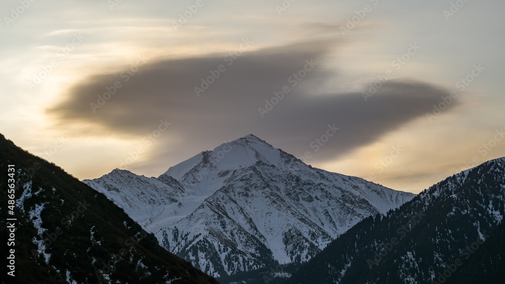 Cloudy dawn over a mountain peak Cloudy dawn over a mountain peak