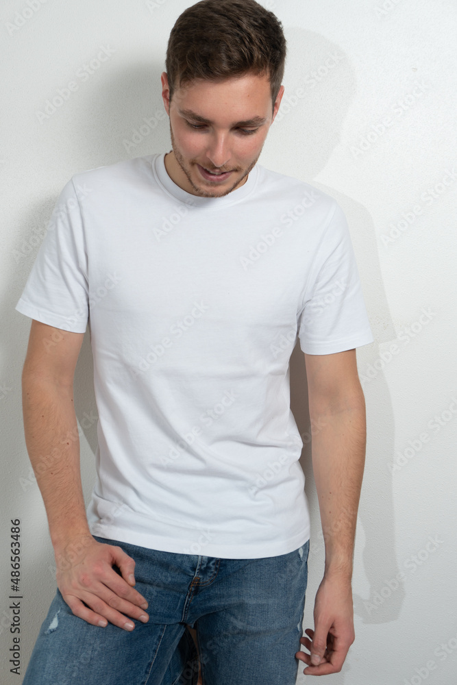 Fototapeta premium Handsome young guy with beard looking at camera, posing on white background.