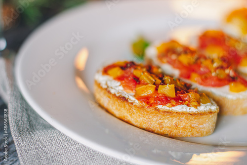 Catering table set service at restaurant before party. Canapes bruschetta with seeds, mozarella and tomatos