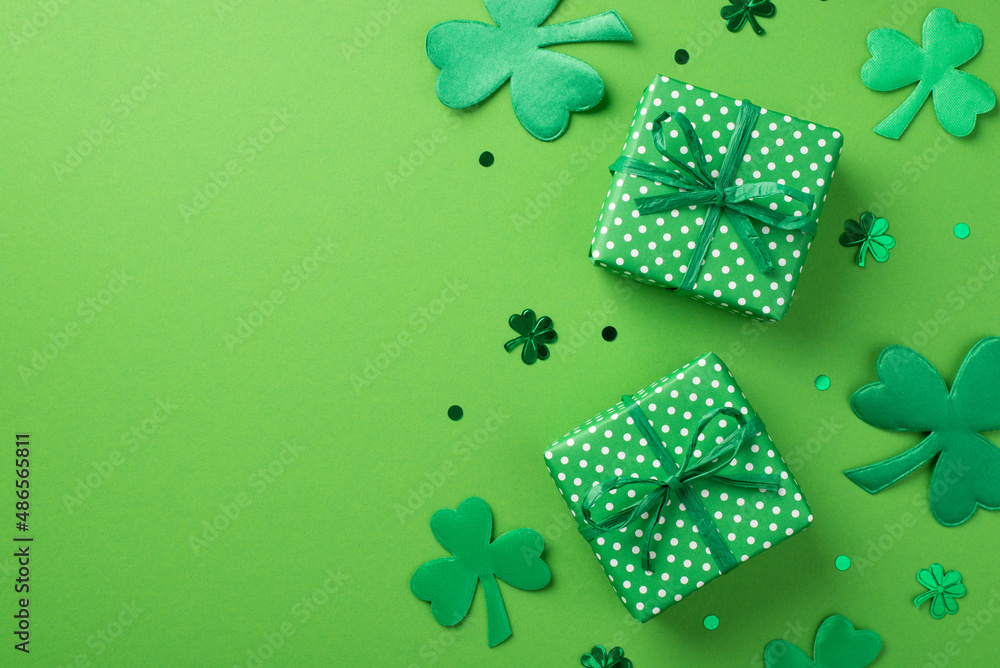Top view photo of st patrick's day decorations two green gift boxes with polka dot pattern clover shaped confetti and trefoils on isolated pastel green background with copyspace - obrazy, fototapety, plakaty 