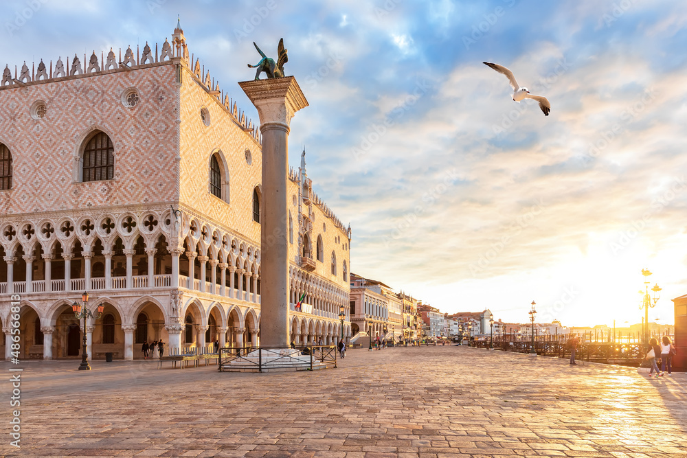 Seagull flies by the Venice pier at sunset, Italy