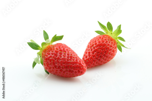 Two strawberries close up on white background. Fresh ripe whole strawberries.