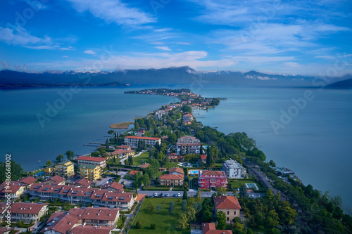 Drone view of Scaliger Castle of Sirmione at sunrise. Sirmione, Lake Garda, Italy aerial view. Sirmione on Lake Garda drone view. Sirmione at high altitude, Lake Garda, Italy.