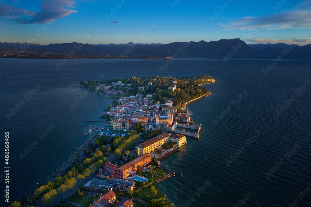 Aerial panorama of Sirmione. Sirmione Lake Garda Italy aerial view. Sirmione on Lake Garda drone view. Drone view of Sirmione at sunrise. Panorama of Lake Garda. Sirmione, Lake Garda, Italy.