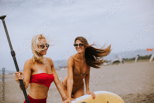 Two young women with paddle...