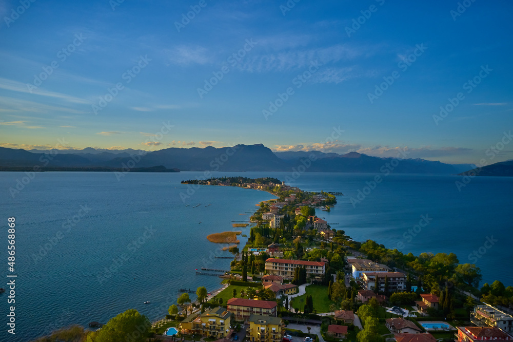 Sirmione, Lake Garda, Italy. Drone view of Sirmione at sunrise. Sirmione Lake Garda Italy aerial view. Aerial panorama of Sirmione. Sirmione on Lake Garda drone view. Panorama of Lake Garda.
