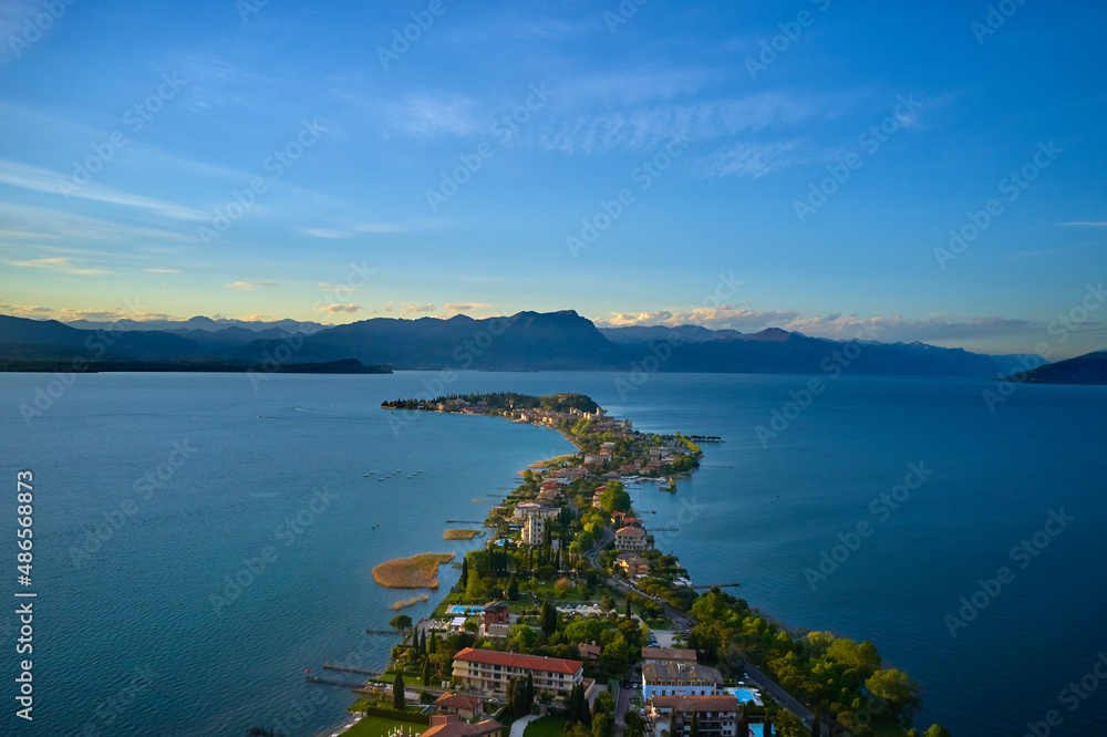 Sirmione, Lake Garda, Italy. Drone view of Sirmione peninsula at sunset. Sirmione Lake Garda Italy aerial view. Aerial panorama of Sirmione. Sirmione on Lake Garda drone view. Panorama of Lake Garda.