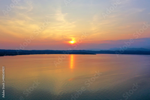 Sunrise over Lake Garda. Reflection of the morning sun in the water. © Berg