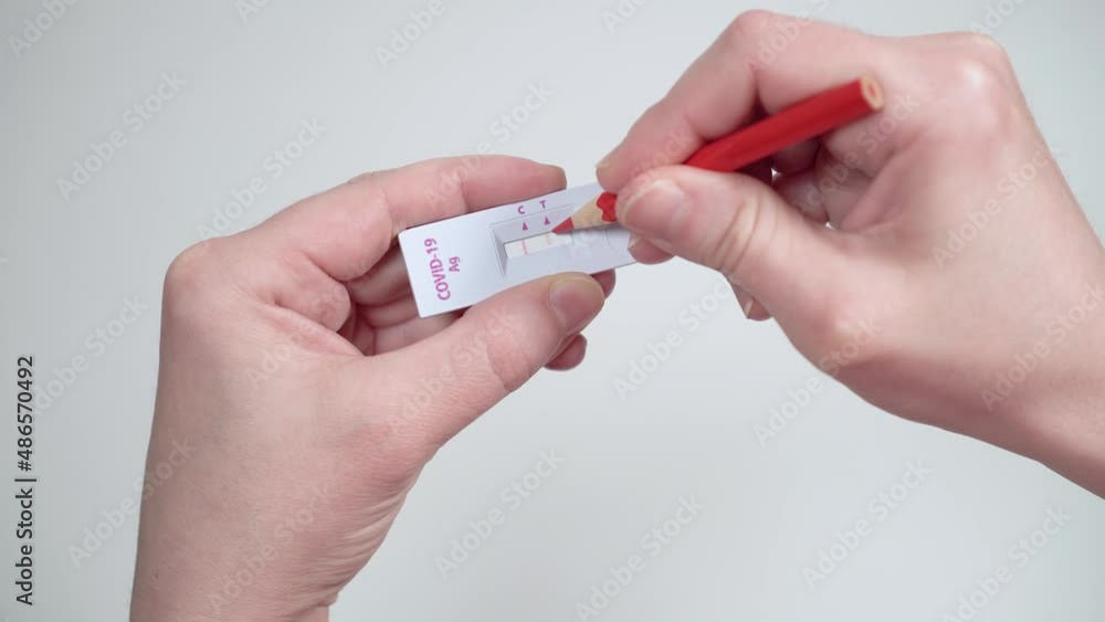 A person fakes the positive result of a coronavirus COVID-19 test. The concept of falsifying results, overstating epidemic statistics or conspiracy theory. A person fakes the positive result of a coronavirus COVID-19 test. The concept of falsifying results, overstating epidemic statistics or conspiracy theory.