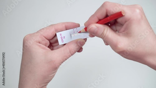 A person fakes the positive result of a coronavirus COVID-19 test. The concept of falsifying results, overstating epidemic statistics or conspiracy theory.