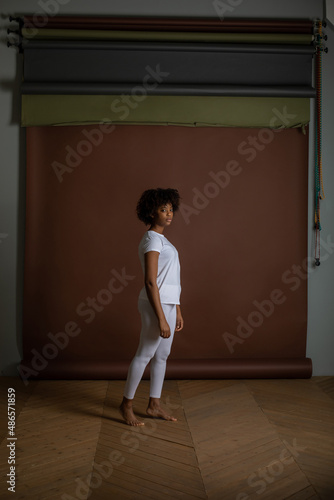 African American girl in a white T-shirt and leggings. Mock-up.
