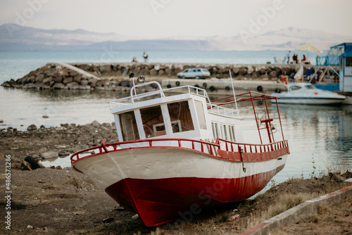 Abondaned wooden boat in foreground, near Van Lake in Turkey photo