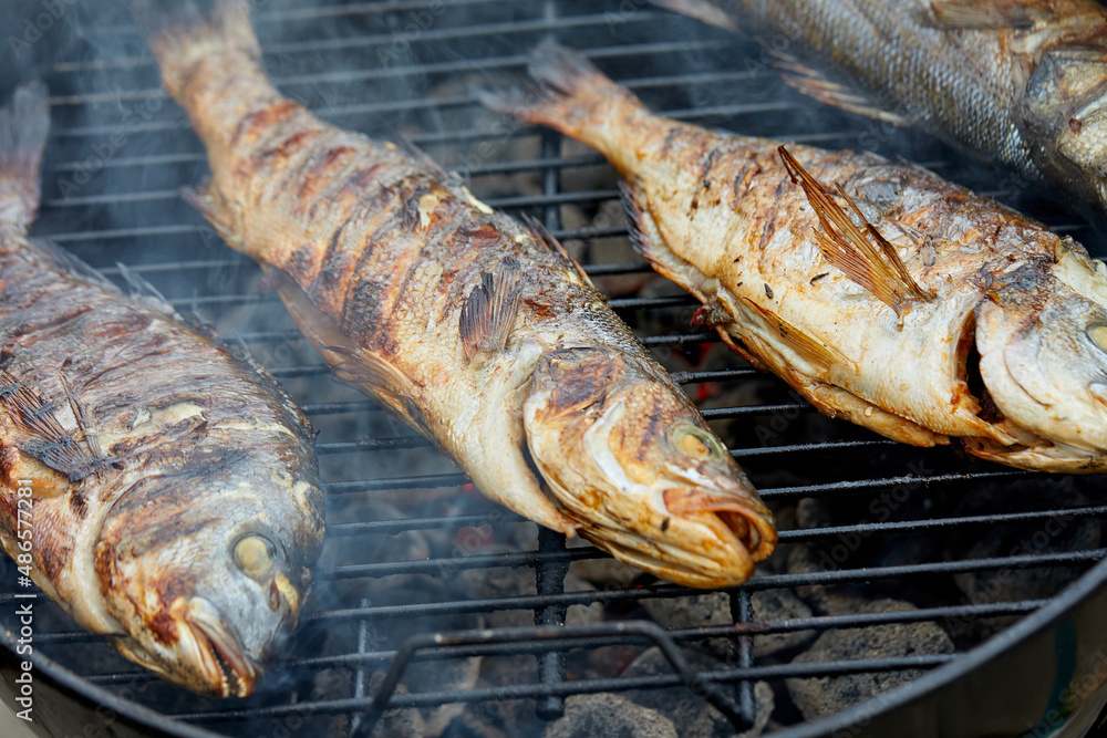 Gilt-head bream fish fried on the grill outdoor. Gilt-head bream fish fried on the grill outdoor.