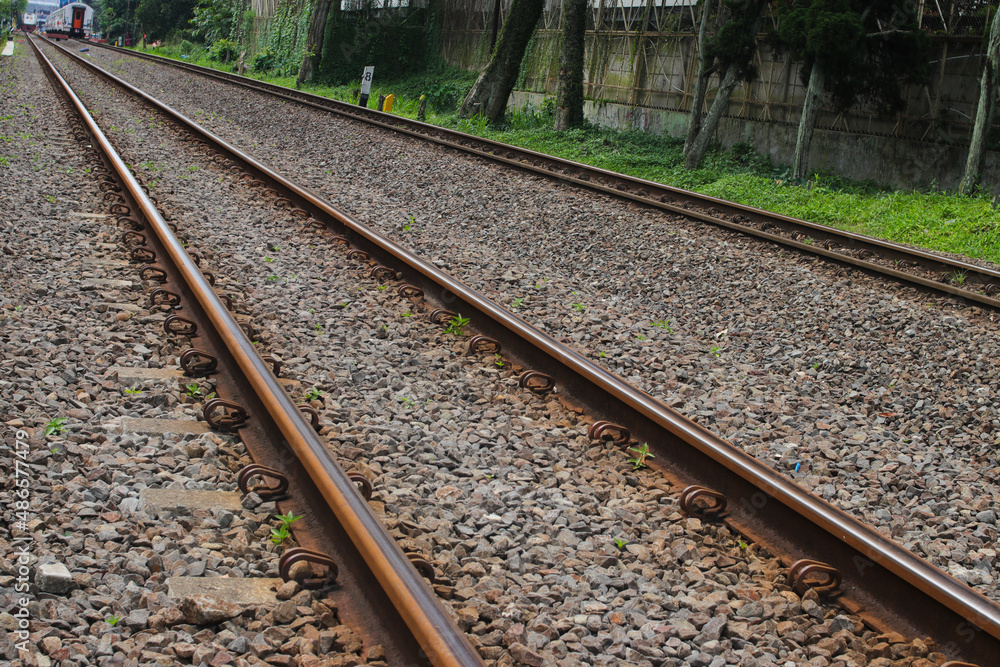 Rusty train tracks with pebbles in Indonesia railways Rusty train tracks with pebbles in Indonesia railways