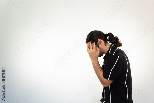 portrait of a hispanic man with a headache, stress and frustration on a white background