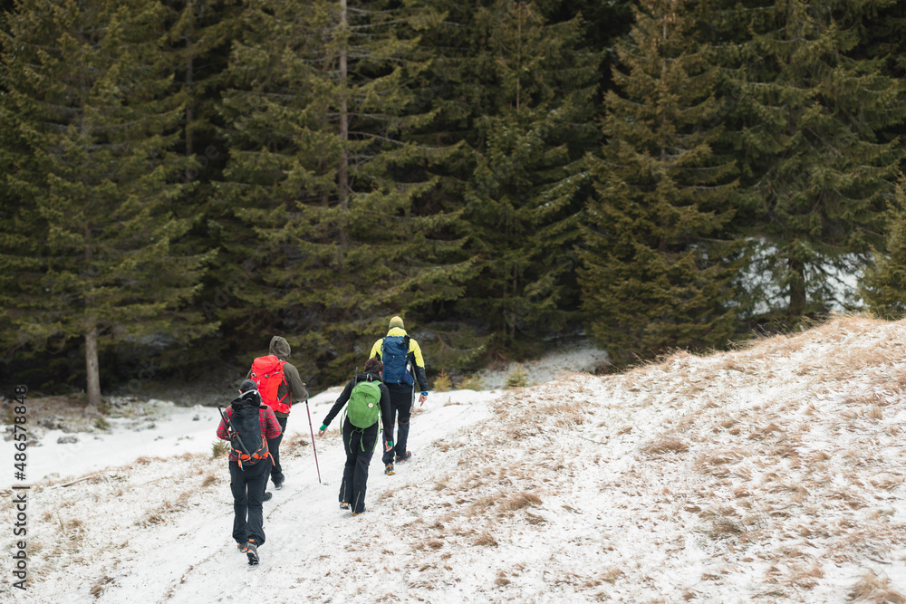 People hiking in beautiful winter mountains for winter sport activity snow mountain hills. Going for hikes in the winter for winter sports like winter hiking and cross-country skiing is very rewarding