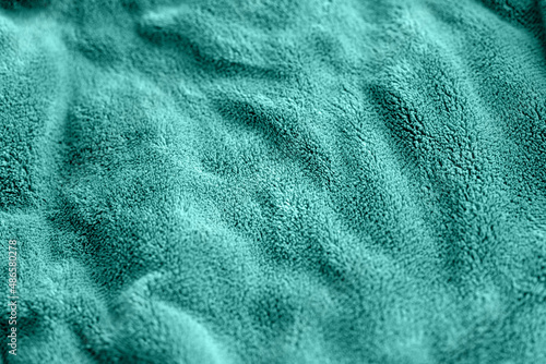 turquoise delicate soft background of fur plush smooth fabric. Texture of aquamarine soft fleecy blanket textile. Faux fur textile background