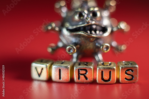 Strong angry virus with a face. The coronavirus is slightly blurred. A type of virus made of metal
