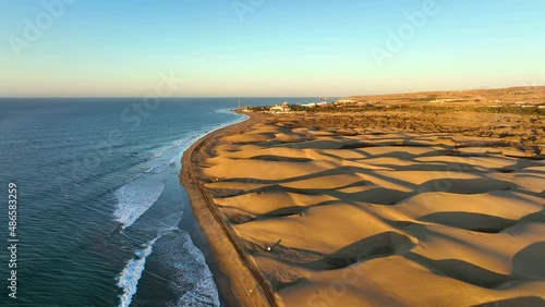 Sand dunes meet the Atlantic Ocean. Top view of Maspalomas sand dunes. Aerial view of Gran Canaria Island. photo