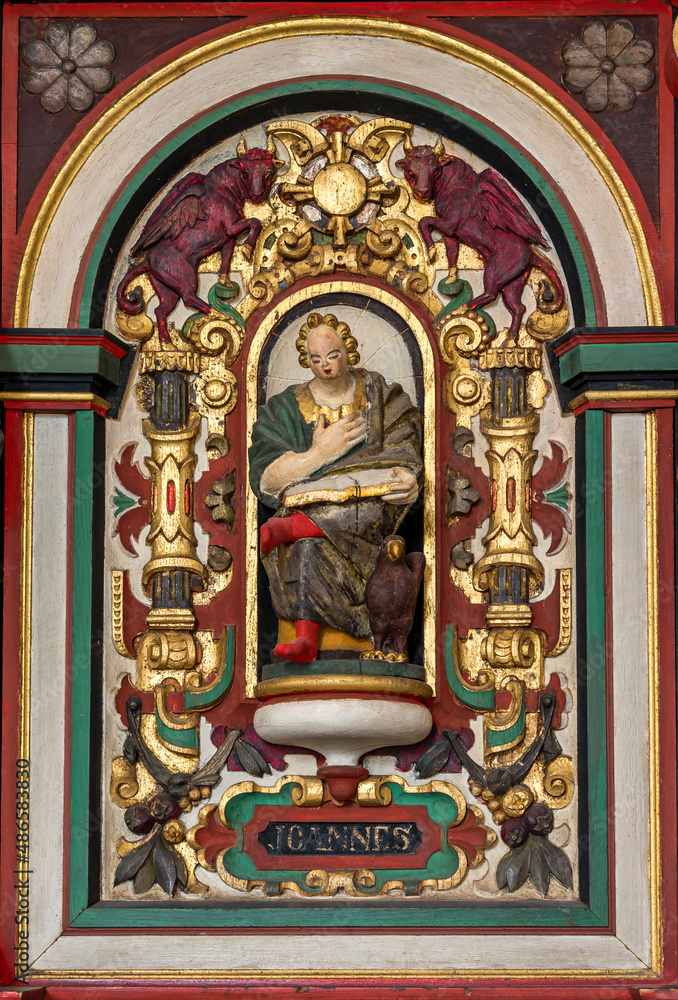 Obraz premium colourful wooden sculpture of St. John the evangelist with his symbol the eagle