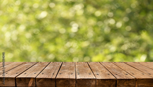 Old empty wooden table - green spring background
