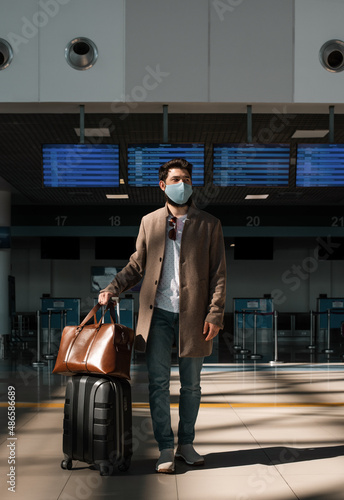 Male traveler in airport terminal during epidemic photo