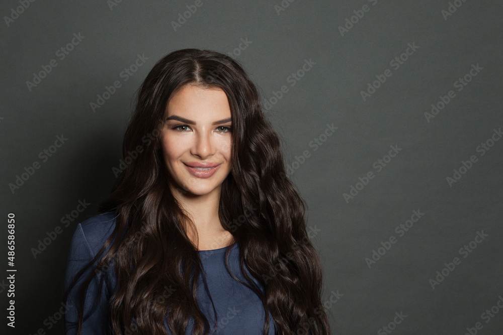 Beauty portrait of cute woman brunette smiling on dark gray background Beauty portrait of cute woman brunette smiling on dark gray background