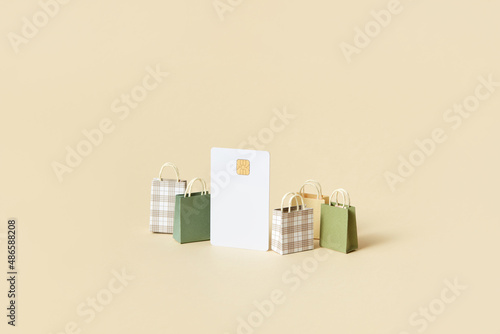 Credit card with chip and shopping bags in studio photo