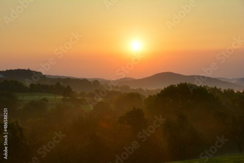 Morning fog at sunrise in green nature photo