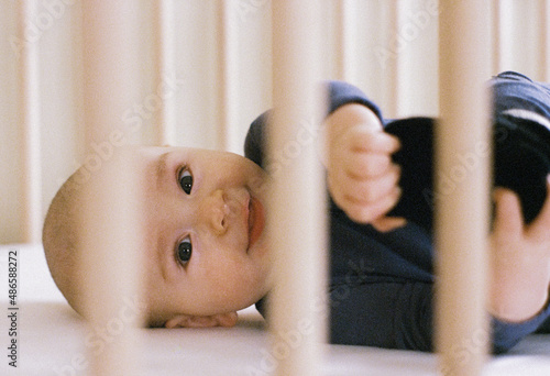 Baby Smiles in his Crib. Shot on 35 mm Film photo