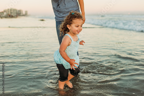 Young girl wading in ocean