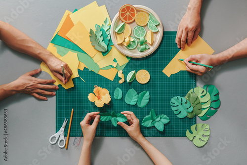 The team makes paper art crafts together photo