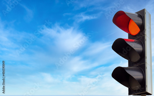 Red traffic light, red color on the traffic light with beautiful blue sky background, copy space