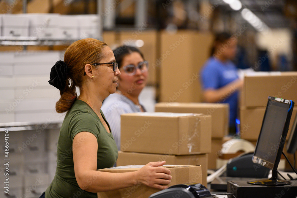 Employees working together at shipping center Employees working together at shipping center