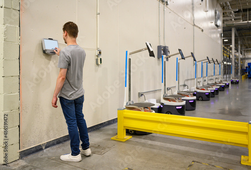  checking in on time clock at warehouse factory  photo