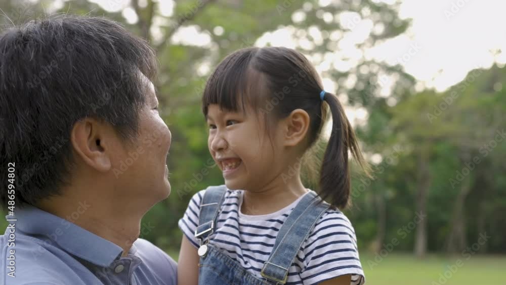 Portrait of fun family daddy and daughter playing in the park. Beautiful child embraces father. Portrait of happy little asian girl, Education care, happy Father's Day close up outdoor. Portrait of fun family daddy and daughter playing in the park. Beautiful child embraces father. Portrait of happy little asian girl, Education care, happy Father's Day close up outdoor.