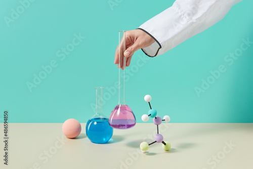 Scientist putting test tube photo
