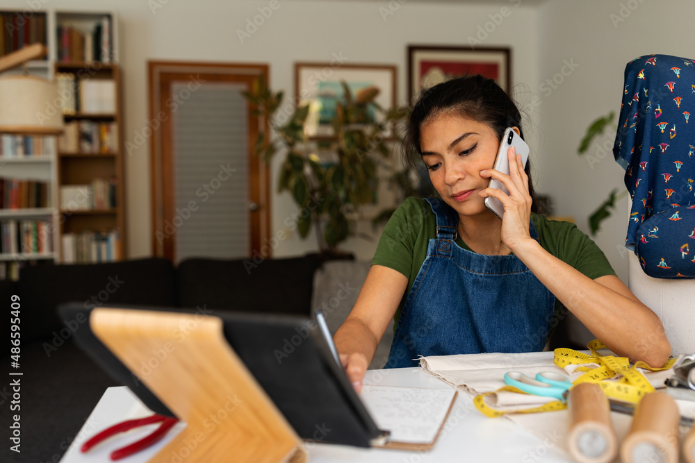 Crafswoman calling by phone at home Crafswoman calling by phone at home