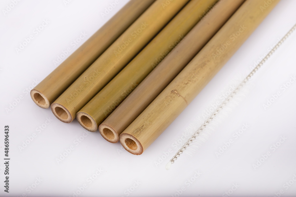 Bamboo straws on a white background. Ecological bamboo straws. Thanks to these bamboo straws, we can be a more environmentally conscious society. Say no to plastic. Bamboo straws on a white background. Ecological bamboo straws. Thanks to these bamboo straws, we can be a more environmentally conscious society. Say no to plastic.