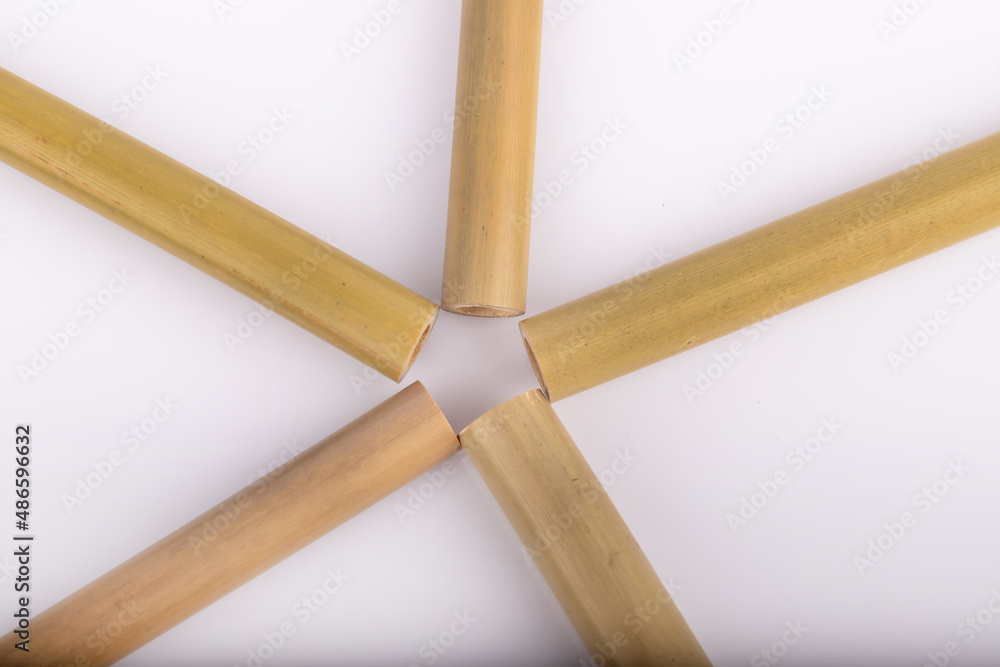 Bamboo straws on a white background. Ecological bamboo straws. Thanks to these bamboo straws, we can be a more environmentally conscious society. Say no to plastic. Bamboo straws on a white background. Ecological bamboo straws. Thanks to these bamboo straws, we can be a more environmentally conscious society. Say no to plastic.