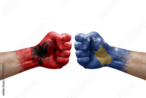 Two hands punch to each others on white background. Country flags painted fists, conflict crisis concept between albania and kosovo