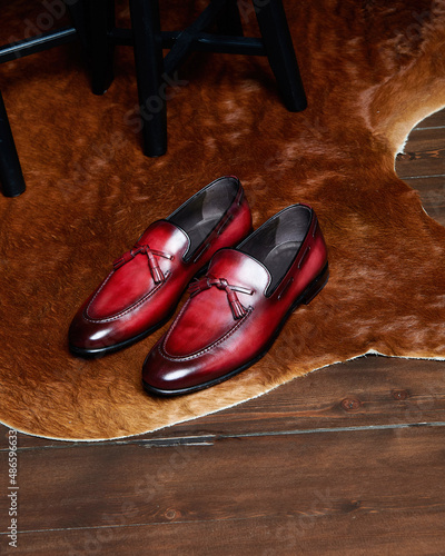 Pair of red leather mens shoes on calfskin.