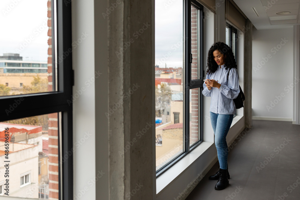 Woman checking phone at empty apartment Woman checking phone at empty apartment