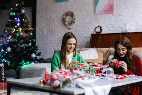 Teen and woman making decor during Christmas time  photo