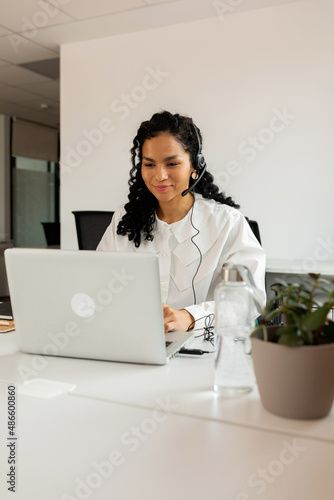 Telemarketing woman working in office photo