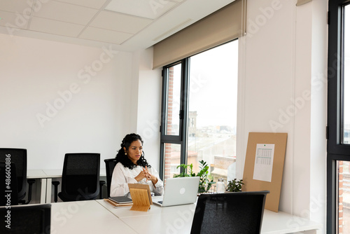 Young woman using laptop at office