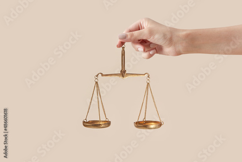 Woman holding golden scales