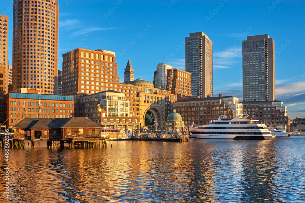 Downtown Boston waterfront around Rowes Wharf lit up by morning sun on