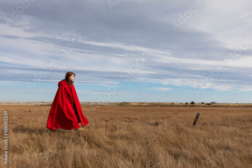 Fall fashion Girl walks with elegant Red cape  coat photo