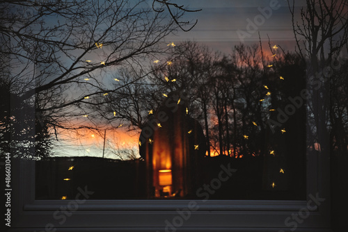 Early morning double exposure wintery reflection in a window with fairy lights photo